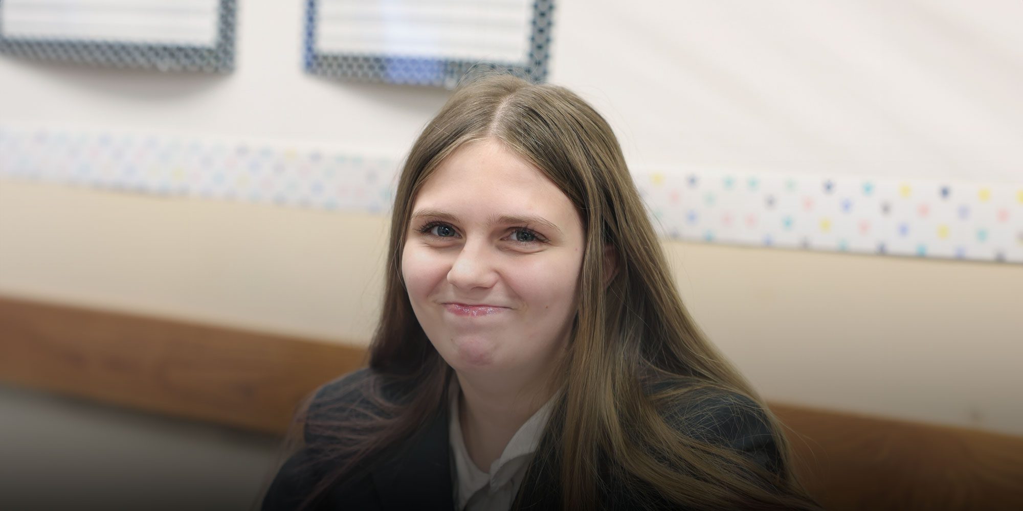Smiling student sitting at desk